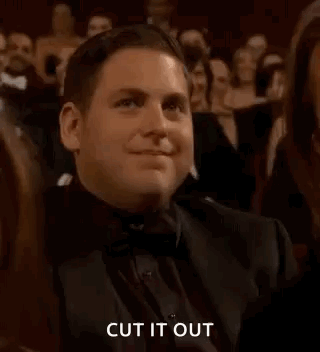 A Man In A Tuxedo Is Clapping In A Crowd At An Awards Show . GIF
