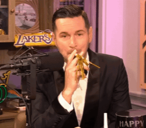 A Man In A Tuxedo Is Eating Noodles In Front Of A Lakers Candy Bar GIF
