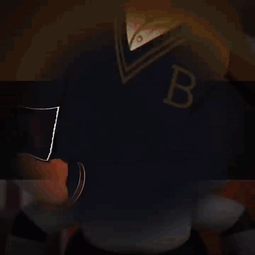 A Man In A Tuxedo Is Holding A Bat With The Letter B On It GIF