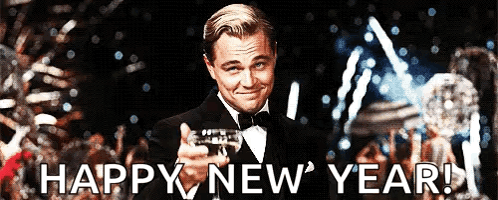 A Man In A Tuxedo Is Holding A Trophy And The Words Happy New Year Are Below Him GIF