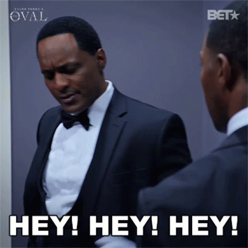 A Man In A Tuxedo Is Looking At Himself In The Mirror And Says Hey Hey Hey GIF