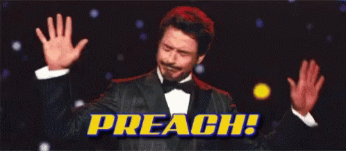 A Man In A Tuxedo Is Raising His Hands In The Air With The Words Preach Behind Him . GIF