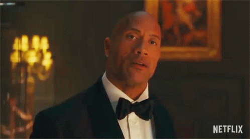 A Man In A Tuxedo Is Saying `` You 'Re Under Arrest '' In A Room . GIF