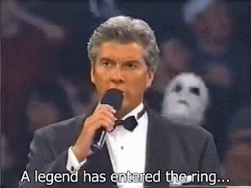 A Man In A Tuxedo Is Talking Into A Microphone And Saying `` A Legend Has Entered The Ring ... '' GIF