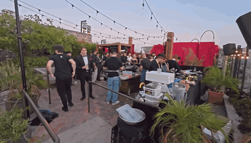 A Man In A Tuxedo Stands In Front Of A Crowd GIF