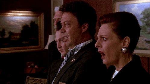 A Man In A Tuxedo Stands Next To A Woman GIF