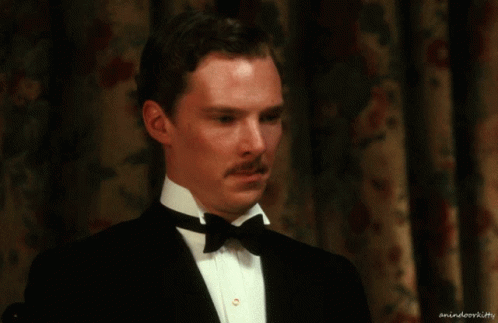 A Man In A Tuxedo With A Bow Tie Has A Watermark That Says Animateorkitty GIF