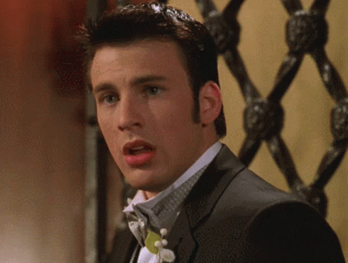 A Man In A Tuxedo With A Bow Tie Is Making A Surprised Face GIF