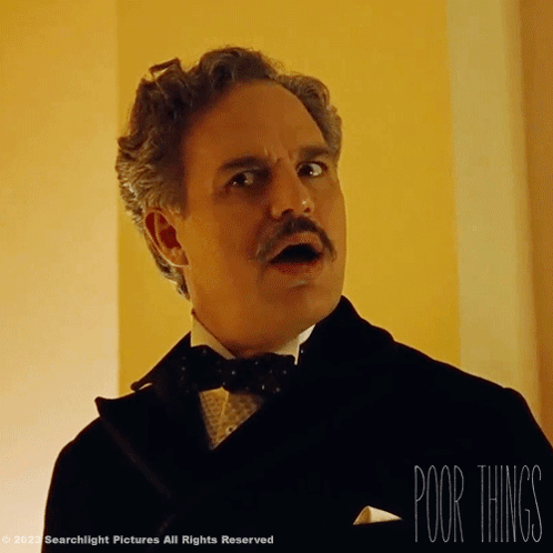 A Man In A Tuxedo With A Mustache And The Words " Poor Things " Below Him GIF