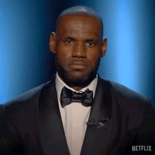 a man in a tuxedo with a netflix logo on the bottom