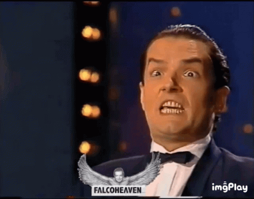 A Man In A Tuxedo With His Mouth Open And A Falconheaven Logo In The Background GIF