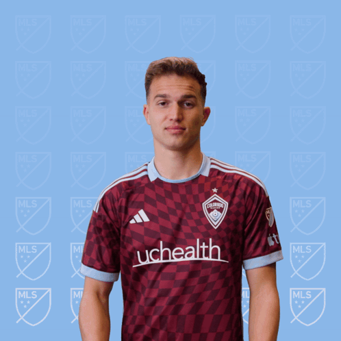 A Man In A Uchealth Jersey Holds A Red Card GIF