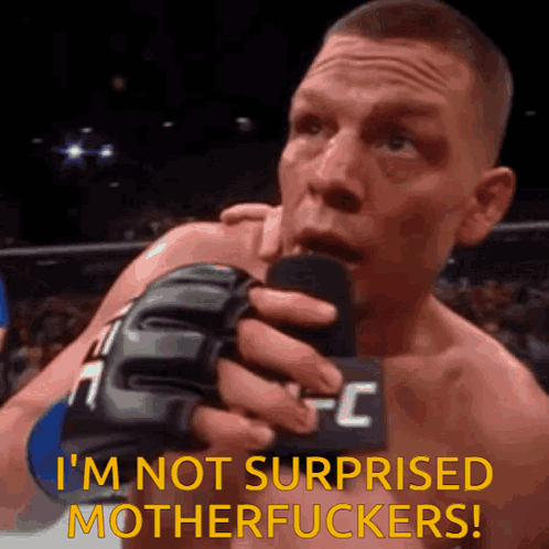 a man in a ufc glove is holding a microphone and saying i 'm not surprised motherfuckers