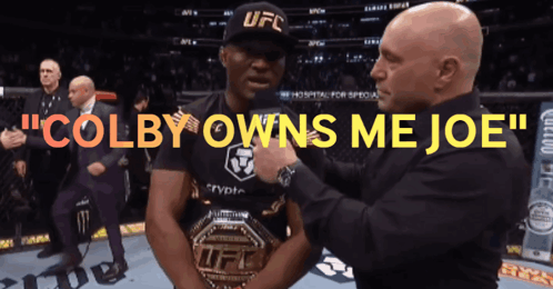 A Man In A Ufc Hat Is Being Pinned By Another Man GIF
