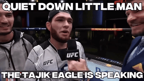 A Man In A Ufc Jersey Is Talking Into A Microphone GIF