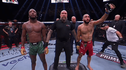A Man In A Ufc Shorts Is Holding A Bottle Of Energy Drink GIF