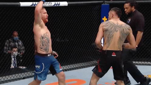 A Man In A Ufc Shorts Stands In A Boxing Ring GIF
