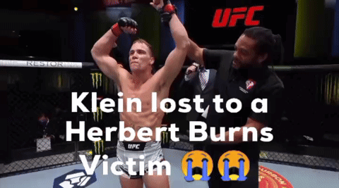 A Man In A Ufc Shorts Stands In A Cage GIF