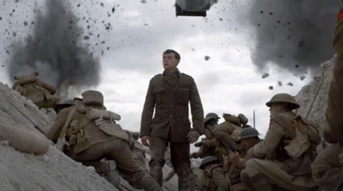 A Man In A Uniform Stands In Front Of A Group Of Soldiers In A Trench GIF