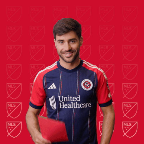 a man in a united healthcare jersey holds a red card