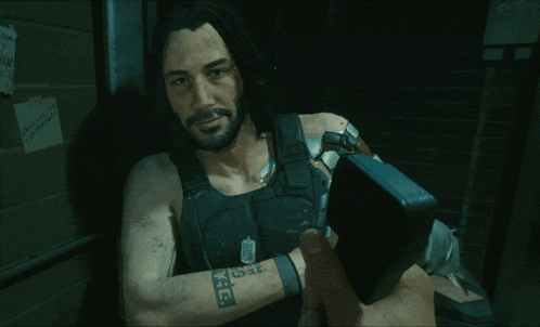 A Man In A Video Game Has A Tattoo On His Arm That Says K.i.d. GIF