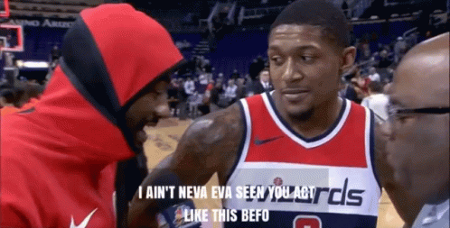 A Man In A Washington Wizards Jersey Talks To Another Man In A Red Hoodie GIF