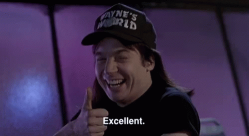 A Man In A Wayne 'S World Hat Gives A Thumbs Up GIF