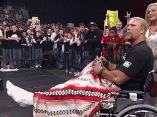 A Man In A Wheelchair Has A Cast On His Leg GIF
