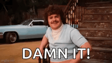 A Man In A Wheelchair Is Sitting On A Set Of Stairs Next To A Car And Says `` Damn It '' . GIF