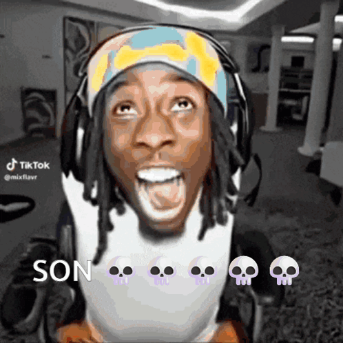 A Man In A Wheelchair Is Wearing Headphones And A Headband With Skulls On It And Says Son GIF