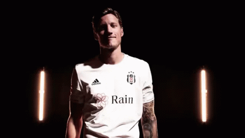 A Man In A White Adidas Shirt Is Making A Peace Sign With His Fingers . GIF