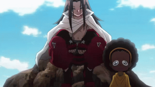 A Man In A White Cape Sits On A Rock Next To A Child GIF