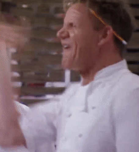 A Man In A White Chef 'S Uniform Is Laughing GIF