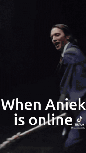 A Man In A White Coat And Tie Is Standing In Front Of A Wall With The Words `` When Anick Is Online '' . GIF
