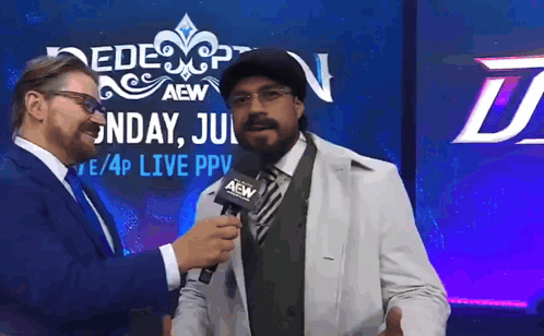 A Man In A White Coat Is Being Interviewed By A Man In A Suit GIF