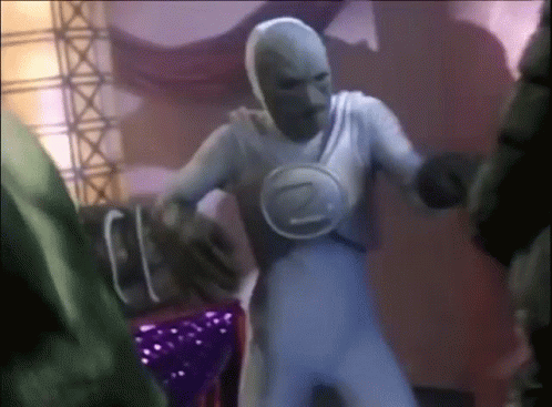 A Man In A White Costume With The Letter Z On His Chest Is Dancing GIF