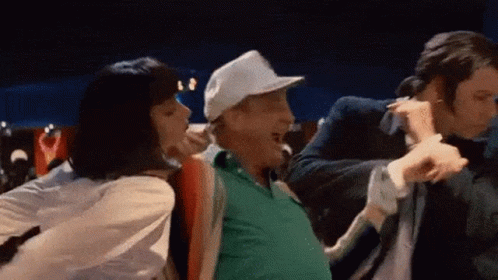 A Man In A White Hat Is Dancing With A Woman In A White Shirt . GIF
