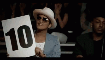 A Man In A White Hat Is Holding Up A Sign That Says 10 GIF