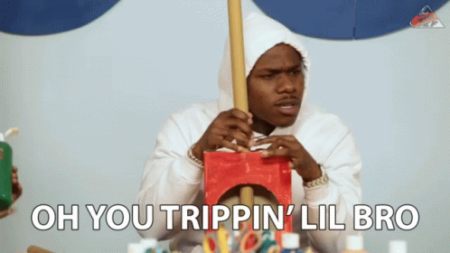 A Man In A White Hoodie Is Holding A Wooden Stick And The Words Oh You Trippin ' Lil Bro Are Above Him GIF