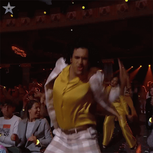 Man In White Jacket Dancing In Front Of Crowd GIF