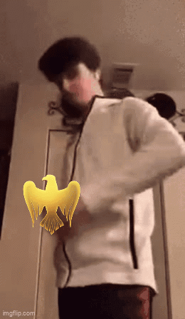 A Man In A White Jacket Is Standing In Front Of A Door With A Yellow Bird On It GIF