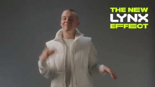 A Man In A White Jacket Stands In Front Of A Sign That Says " The New Lynx Effect " GIF