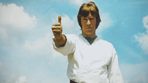 A Man In A White Karate Uniform Is Giving The Thumbs Up GIF