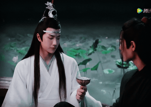 A Man In A White Kimono Is Holding A Bowl In Front Of A Man In A Black Kimono GIF