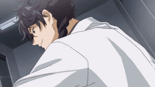 A Man In A White Lab Coat Is Looking Down GIF