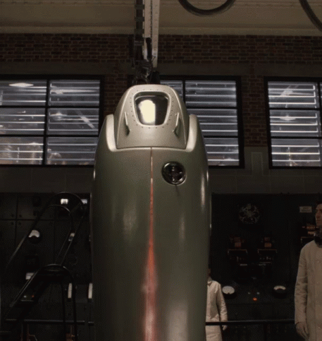A Man In A White Lab Coat Stands In Front Of A Machine That Says ' A ' On It GIF