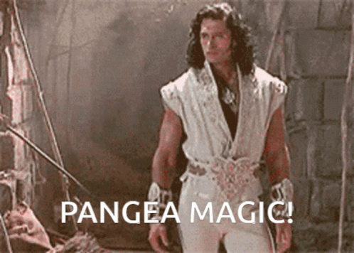 A Man In A White Outfit Is Standing In A Dark Room With The Words Pangea Magic Below Him GIF