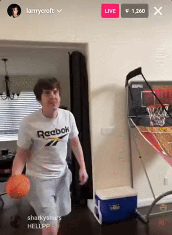 A Man In A White Reebok Shirt Is Playing Basketball GIF