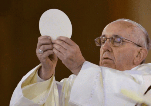 A Man In A White Robe Holds A White Plate In His Hands GIF