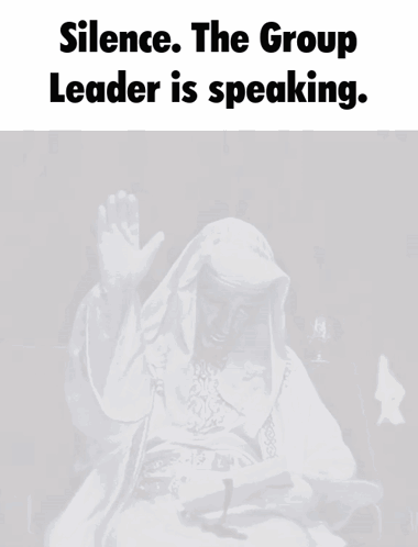 A Man In A White Robe Is Sitting In Front Of A Microphone With The Words " Silence The Group Leader Is Speaking " Above GIF
